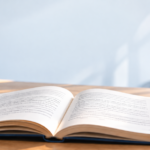 book on table with coffee